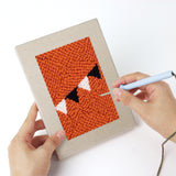 Punching a Halloween Bunting mini canvas with the punch needle