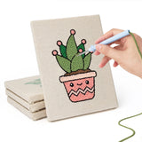 Hand punching one of the Happy Little Planters mini canvases