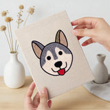 Hand holding a finished Happy Pup Faces mini canvas