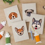 The four finished Happy Pup Faces mini canvases laid out on a table