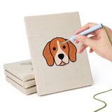Hand punching one of the Happy Pup Faces mini canvases