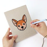 Punching a Happy Pup Faces mini canvas with the punch needle