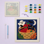 Harvest Basket Cat canvas before and after punching, with the threads and tools