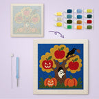 Haunted Apple Tree canvas before and after punching, with the threads and tools