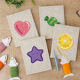 The four finished Heart Candy Mix mini canvases laid out on a table