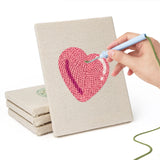 Hand punching one of the Heart Candy Mix mini canvases