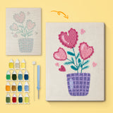 Heart Flower Pot canvas before and after punching, with the threads and tools
