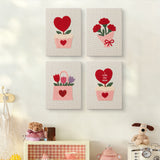 The four Hearts and Bouquets mini canvases on a wall above a shelf