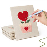 Hand punching one of the Hearts and Bouquets mini canvases