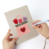 Punching a Hearts and Bouquets mini canvas with the punch needle