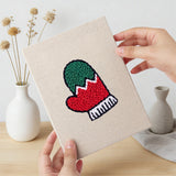 Hand holding a finished Holly and Mitten mini canvas