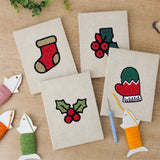 The four finished Holly and Mitten mini canvases laid out on a table
