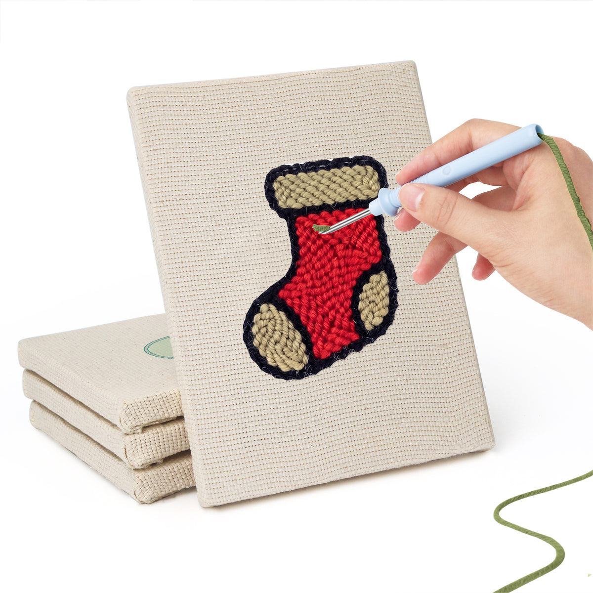 Hand punching one of the Holly and Mitten mini canvases