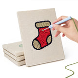 Hand punching one of the Holly and Mitten mini canvases