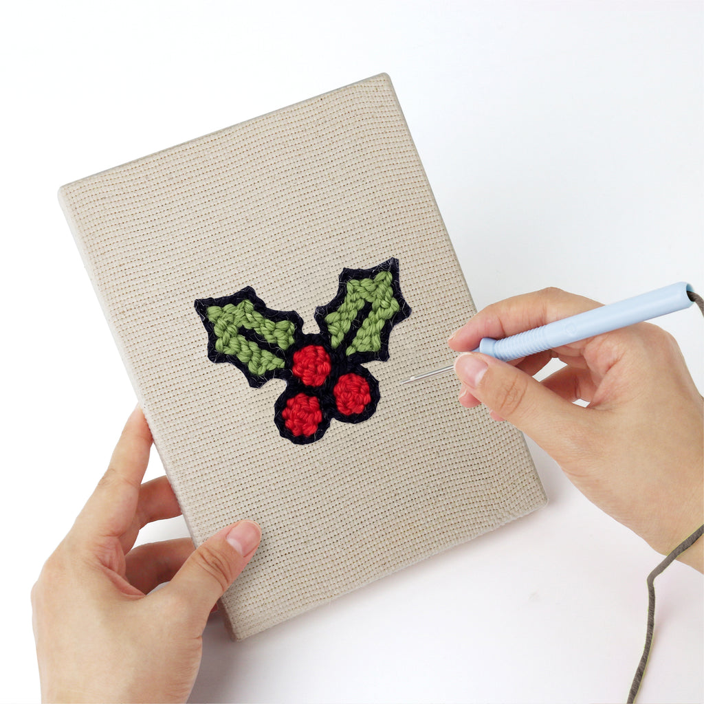 Punching a Holly and Mitten mini canvas with the punch needle