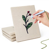 Hand punching one of the Holly and Sprig mini canvases