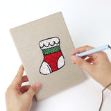 Punching a Holly and Sprig mini canvas with the punch needle