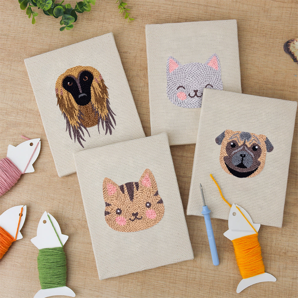 The four finished Hound and Kittens mini canvases laid out on a table