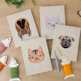 The four finished Hound and Kittens mini canvases laid out on a table