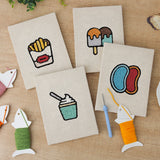 The four finished Jelly Bean Pops mini canvases laid out on a table