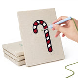 Hand punching one of the Jingle Bells Snowflake mini canvases