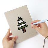 Punching a Jingle Bells Snowflake mini canvas with the punch needle