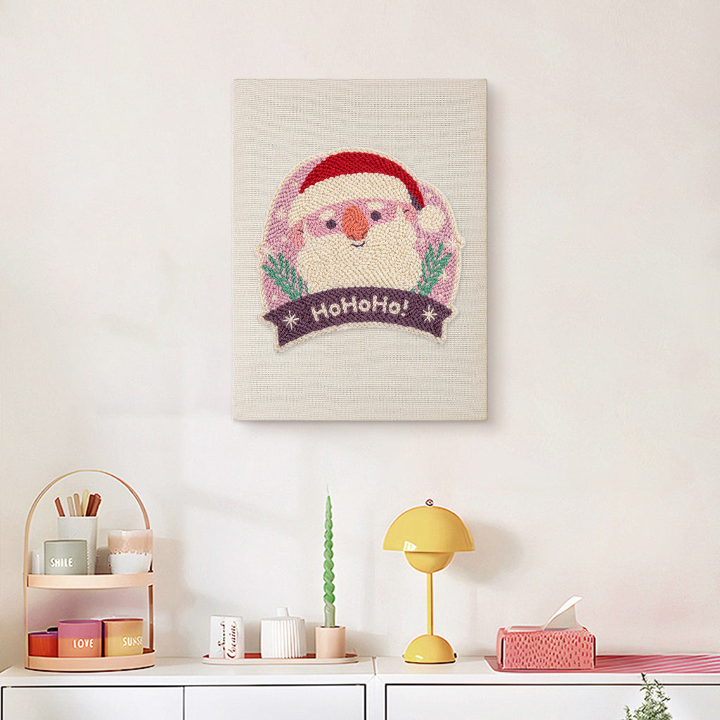 Finished Jolly Santa Badge punch needle canvas on a wall