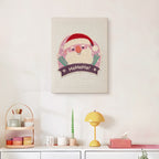 Finished Jolly Santa Badge punch needle canvas on a wall