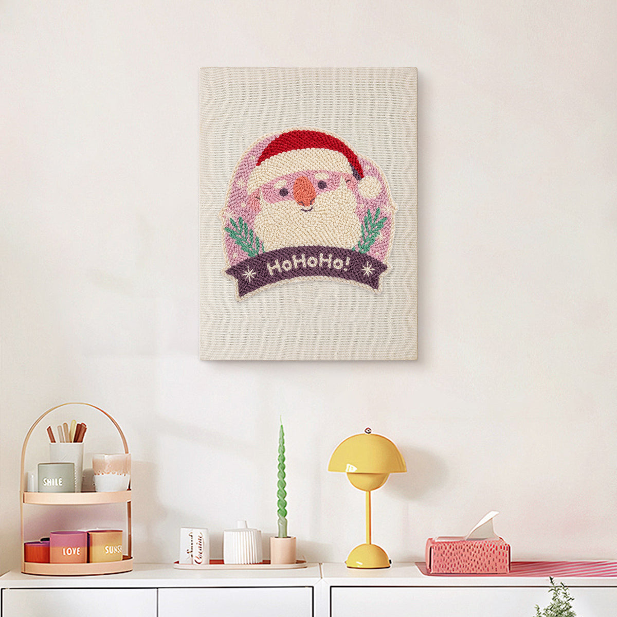 Finished Jolly Santa Badge punch needle canvas on a wall