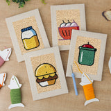 The four finished Kitchen Favorites mini canvases laid out on a table