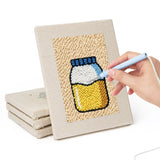 Hand punching one of the Kitchen Favorites mini canvases