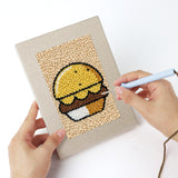 Punching a Kitchen Favorites mini canvas with the punch needle