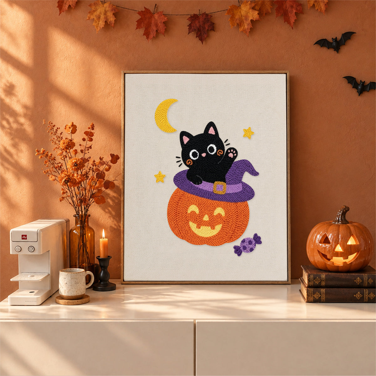 Finished Kitten on a Pumpkin Hat punch needle canvas on a wall