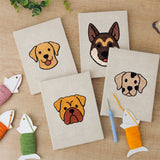 The four finished Labrador and Shepherd mini canvases laid out on a table