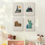 The four Landmark Postcards mini canvases on a wall above a shelf