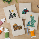 The four finished Landmark Postcards mini canvases laid out on a table