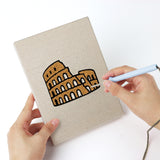 Punching a Landmark Postcards mini canvas with the punch needle