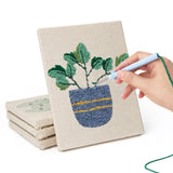 Hand punching one of the Leafy Houseplants mini canvases