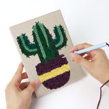 Punching a Leafy Houseplants mini canvas with the punch needle