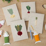 The four finished Leafy Root Veggies mini canvases laid out on a table