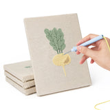 Hand punching one of the Leafy Root Veggies mini canvases