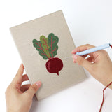 Punching a Leafy Root Veggies mini canvas with the punch needle