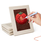 Hand punching one of the Lemon and Broccoli mini canvases