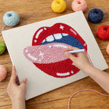 Punching the Licking Red Lips design with the punch needle