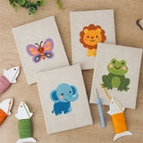 The four finished Lion and Friends mini canvases laid out on a table