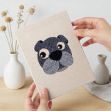 Hand holding a finished Lion and Sheep mini canvas
