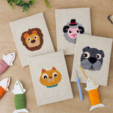 The four finished Lion and Sheep mini canvases laid out on a table