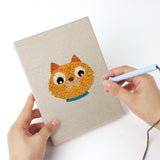 Punching a Lion and Sheep mini canvas with the punch needle