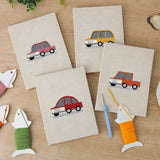 The four finished Little City Cars mini canvases laid out on a table