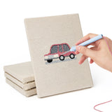 Hand punching one of the Little City Cars mini canvases